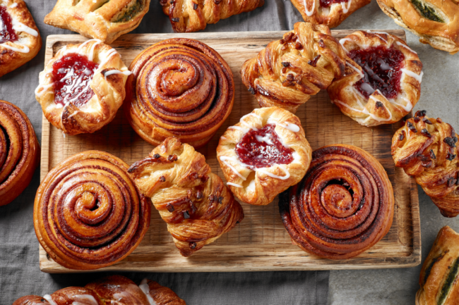 cinnamon roll and other sweet bakes goods on kitchen table