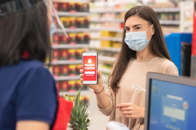 Woman using grocery store coupon