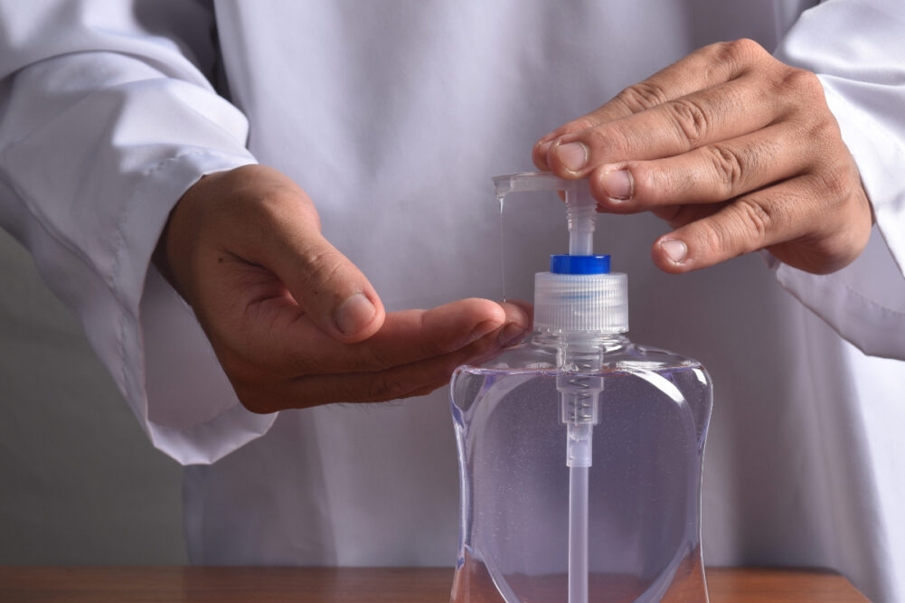 Doctor using hand sanitizer