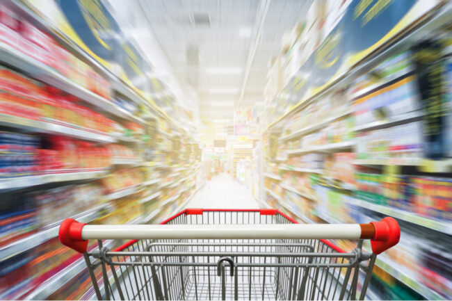 Grocery cart in supermarket aisles