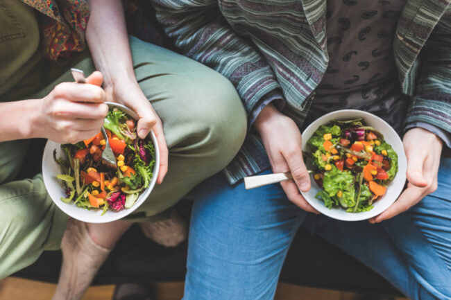 Couple eating salad at home