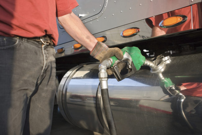 Man fueling up a transport truck