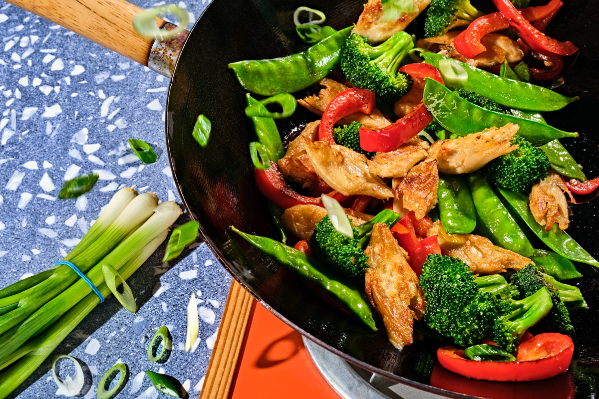 Meat and veggies cooking in a skillet