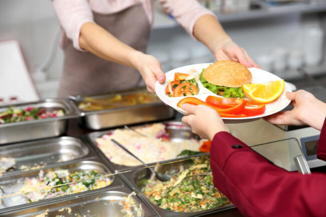 A child recieving a school lunch