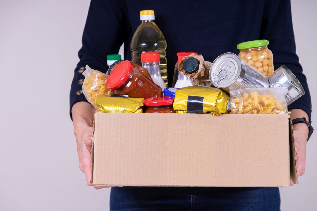 Person holding a box of food