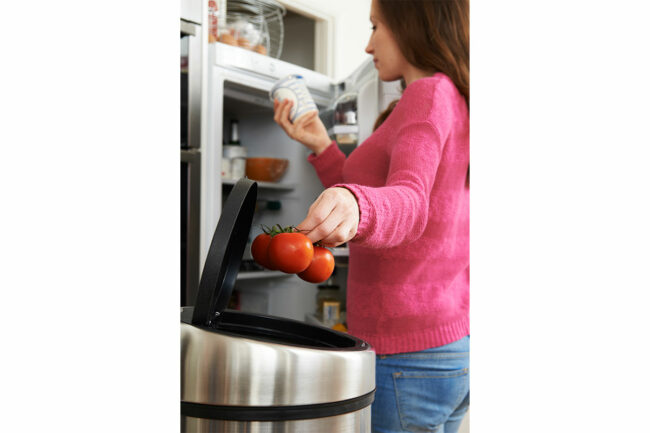 Woman throwing away tomatoes