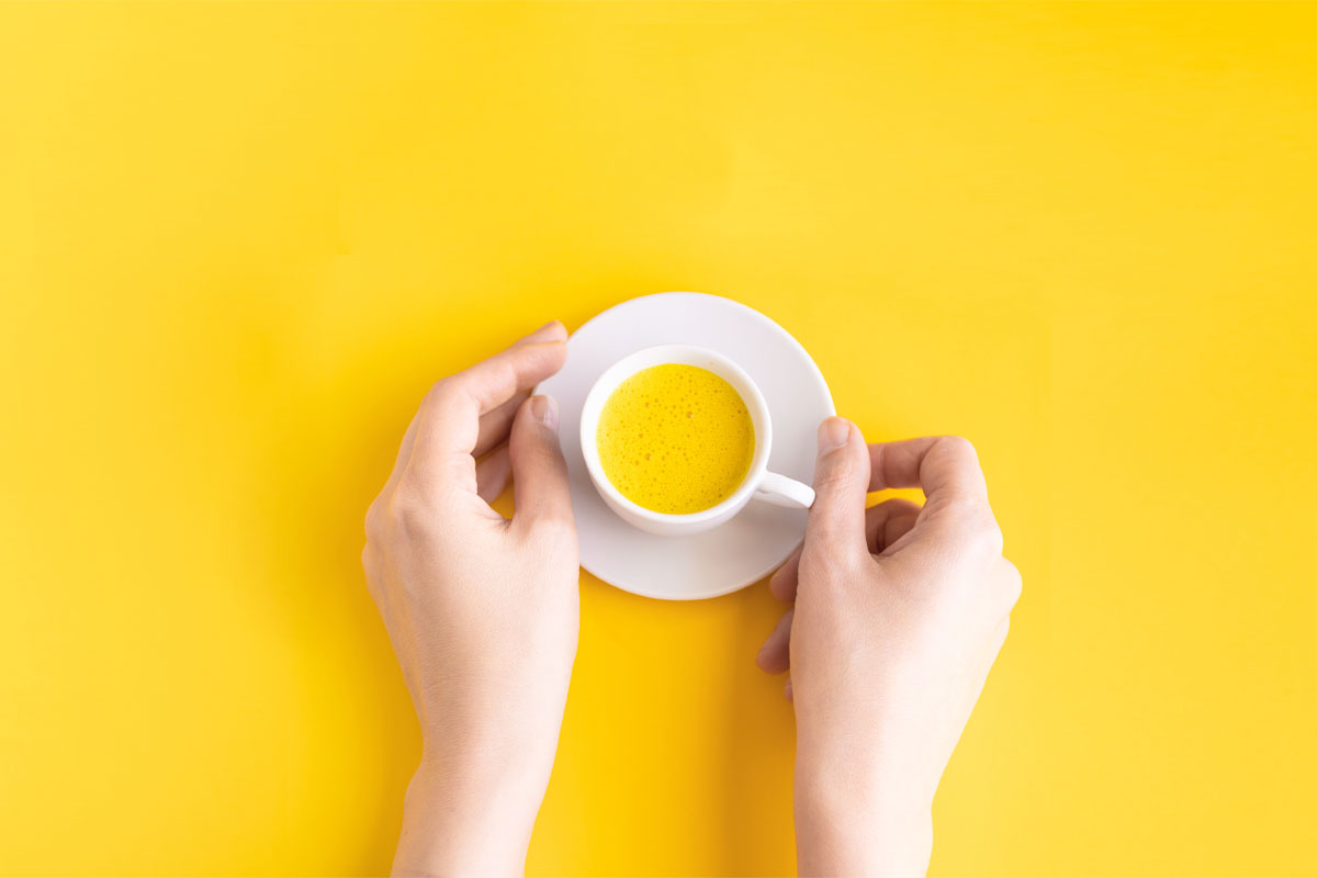 A woman holding golden milk