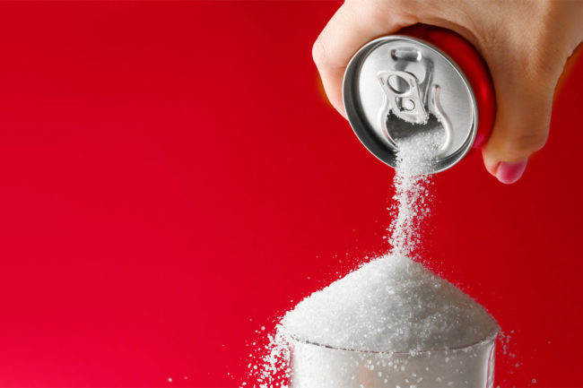 Pouring sugar from a soda can