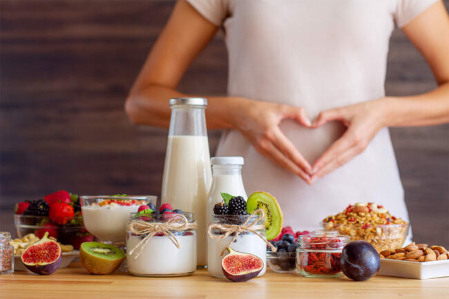 Woman holding heart over stomach