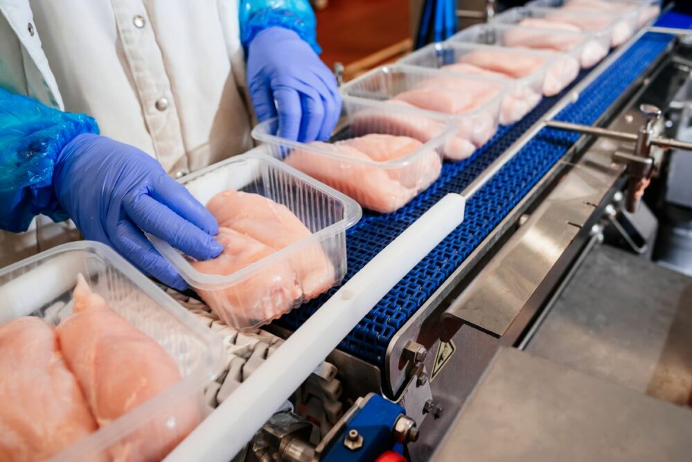 People working on a chicken production line