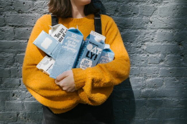 Person holding Oatly products