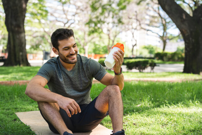 man holding protein shake